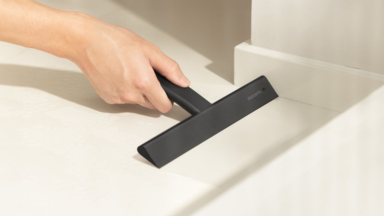 JustHang Compact Squeegee_wiping foam from a countertop